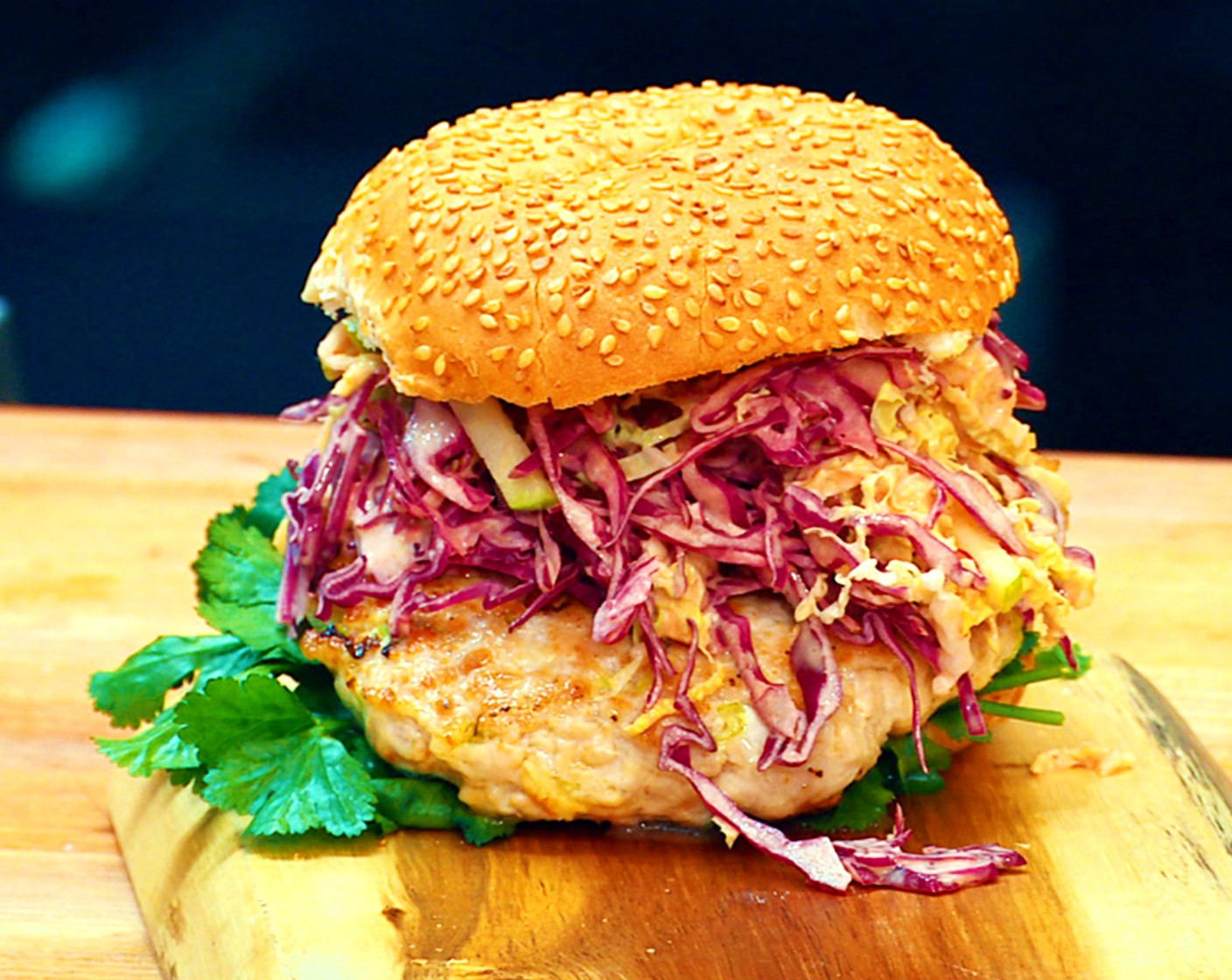 step 5 Assemble the burger: Toast the Sesame Hamburger Buns (2). Place one bottom bun on a plate and top with half of the picked Fresh Cilantro (1 bunch). Place one patty on top and then pile on the slaw and finish with the top bun to create a complete turkey burger.