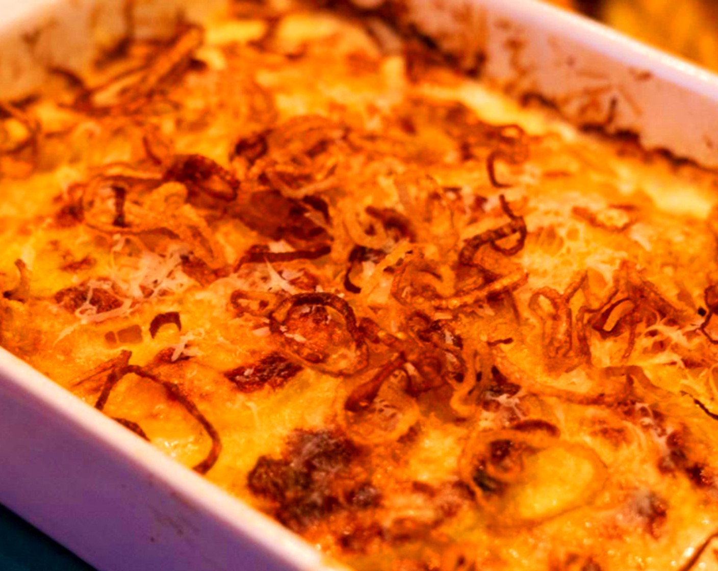 step 13 To serve, once the gratin has rested, top the dish with crispy shallots and serve.