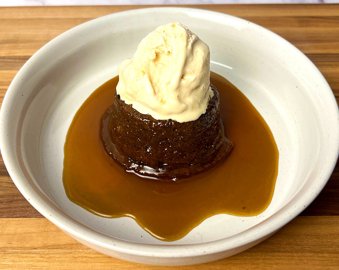 step 8 Turn the cakes out of the cake tins onto a plate. Drizzle the toffee sauce over the cake and serve with a scoop of dulce de leche Ice Cream (to taste).