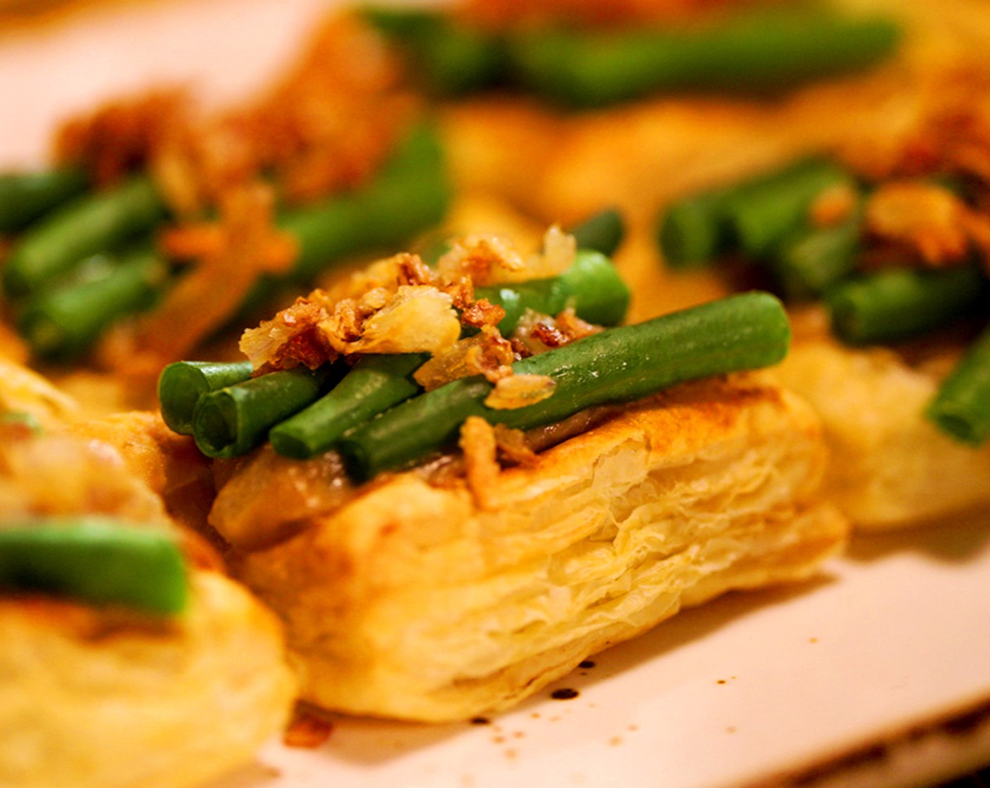 step 16 Gently warm the mushroom gravy and green beans, then fill the centers of each pastry with gravy and top with the green beans and crispy shallots.