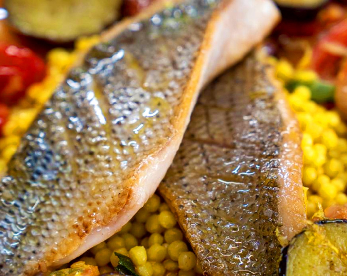 step 12 Assemble: Plate couscous, top with tomato sauce and fish, garnish with lemon wedge.