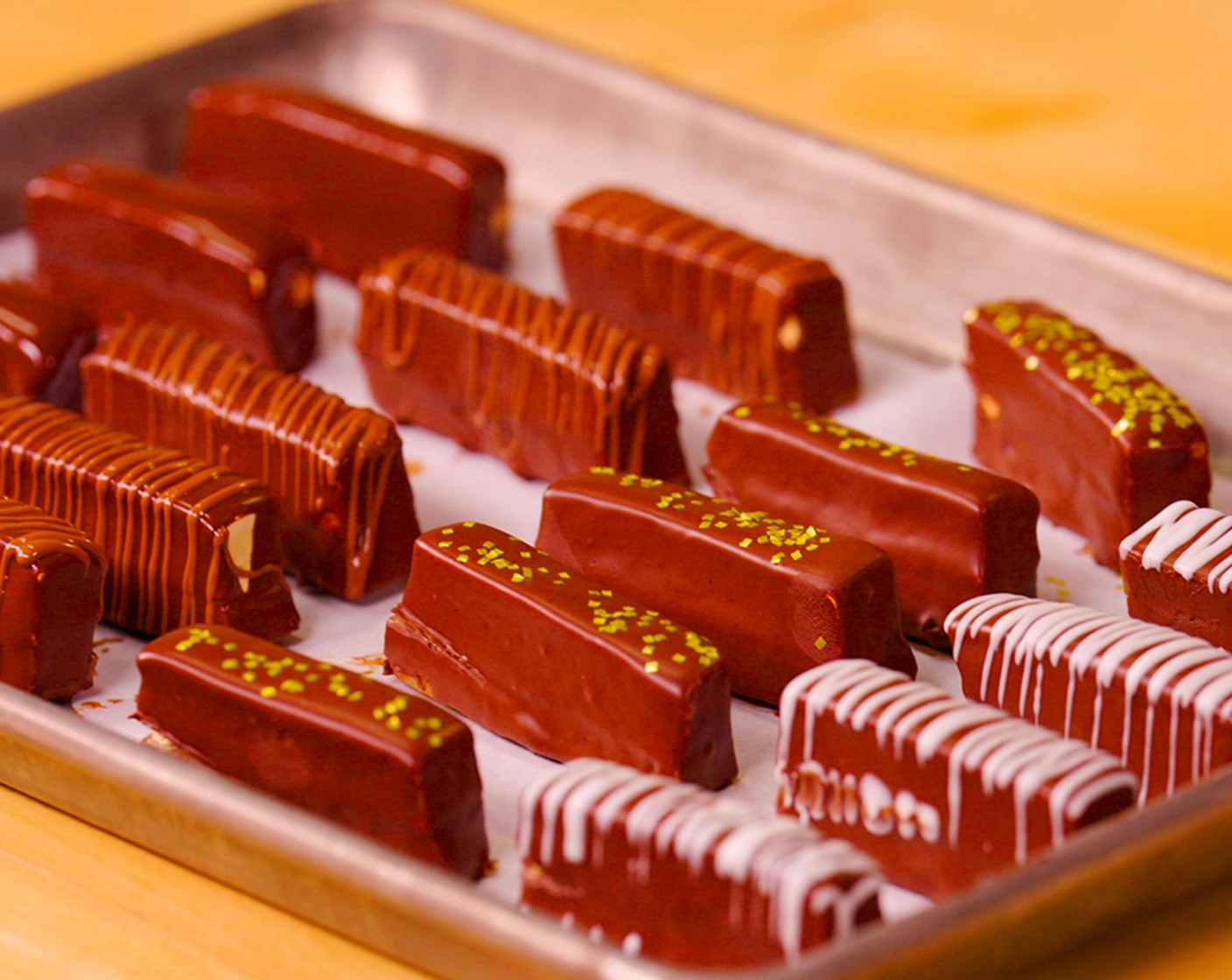 step 12 Cut the candy bar into desired shapes the cleaner you can keep your knife the cleaner your cuts will be, and place in the melted chocolate. Remove from the chocolate using a fork and place on a wire rack to cool.