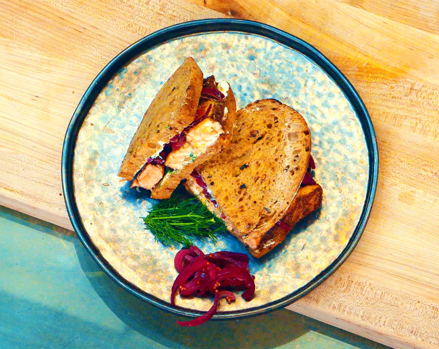 step 11 Divide the salmon between 2 slices of bread. Top the salmon with the pickled onions and place the remaining pieces of bread on top.