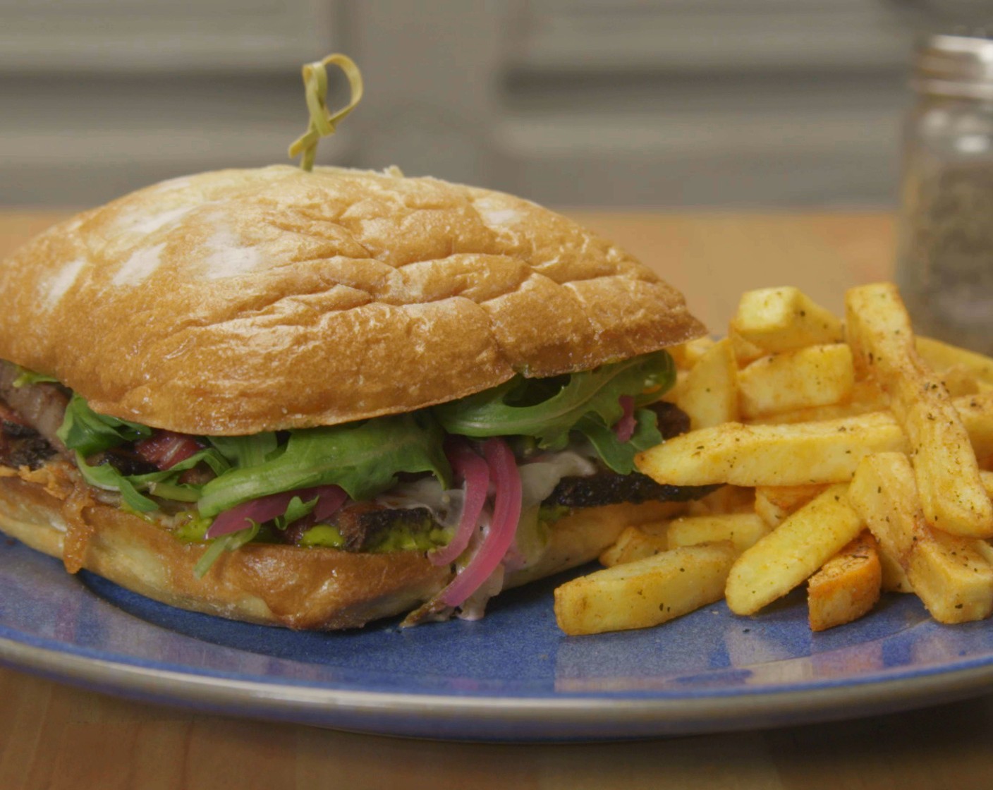 step 9 Place the warm brisket on both sides of the cheese-coated roll. Then place the sandwich under in the oven or until the cheese has melted; about 5-8 minutes. Remove the sandwich from the oven, and top it with aioli, pickled red onions, and crispy fried onions.