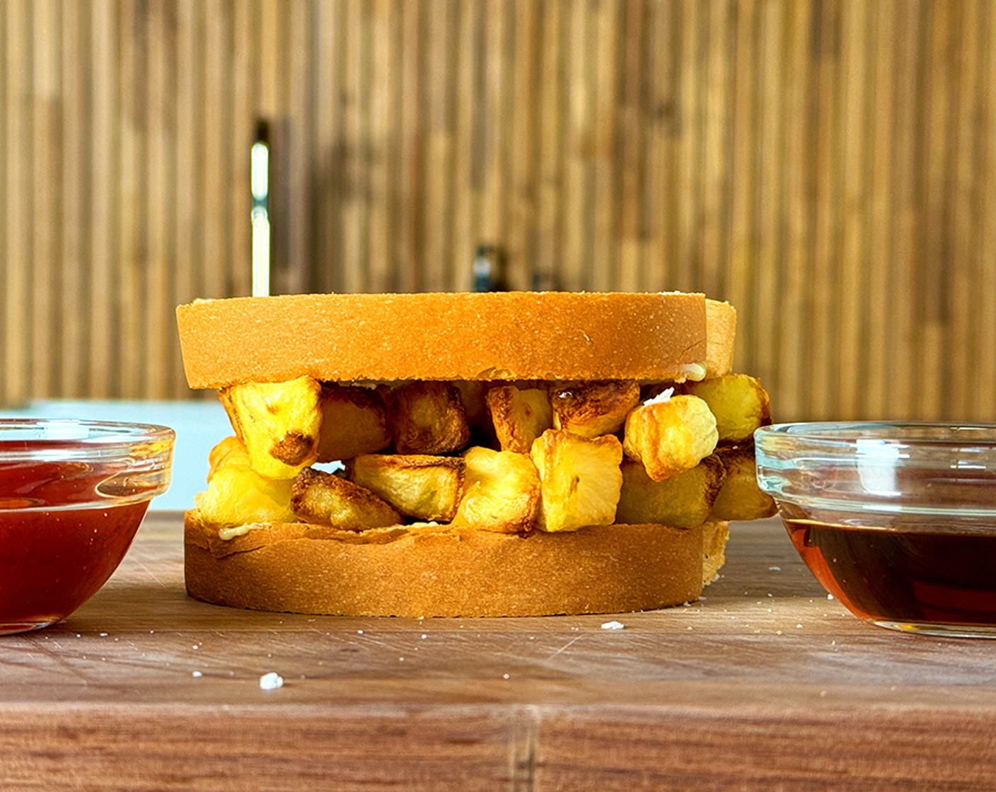 step 3 Season with Finishing Salt (to taste) and drizzle with Malt Vinegar (to taste). Place the chips between the slices of White Bread (2 slices) lathered with Butter (to taste) and serve with Ketchup (to taste).