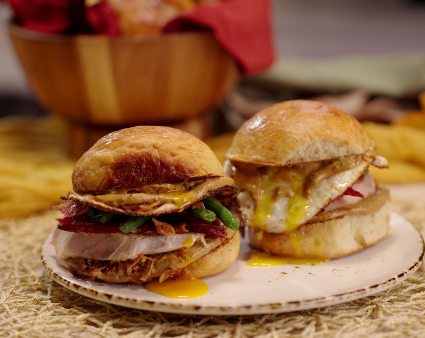 step 5 Spoon the mole mayo over the bottom half of the bun and top with bacon, turkey, green beans, eggs and more fried shallots.