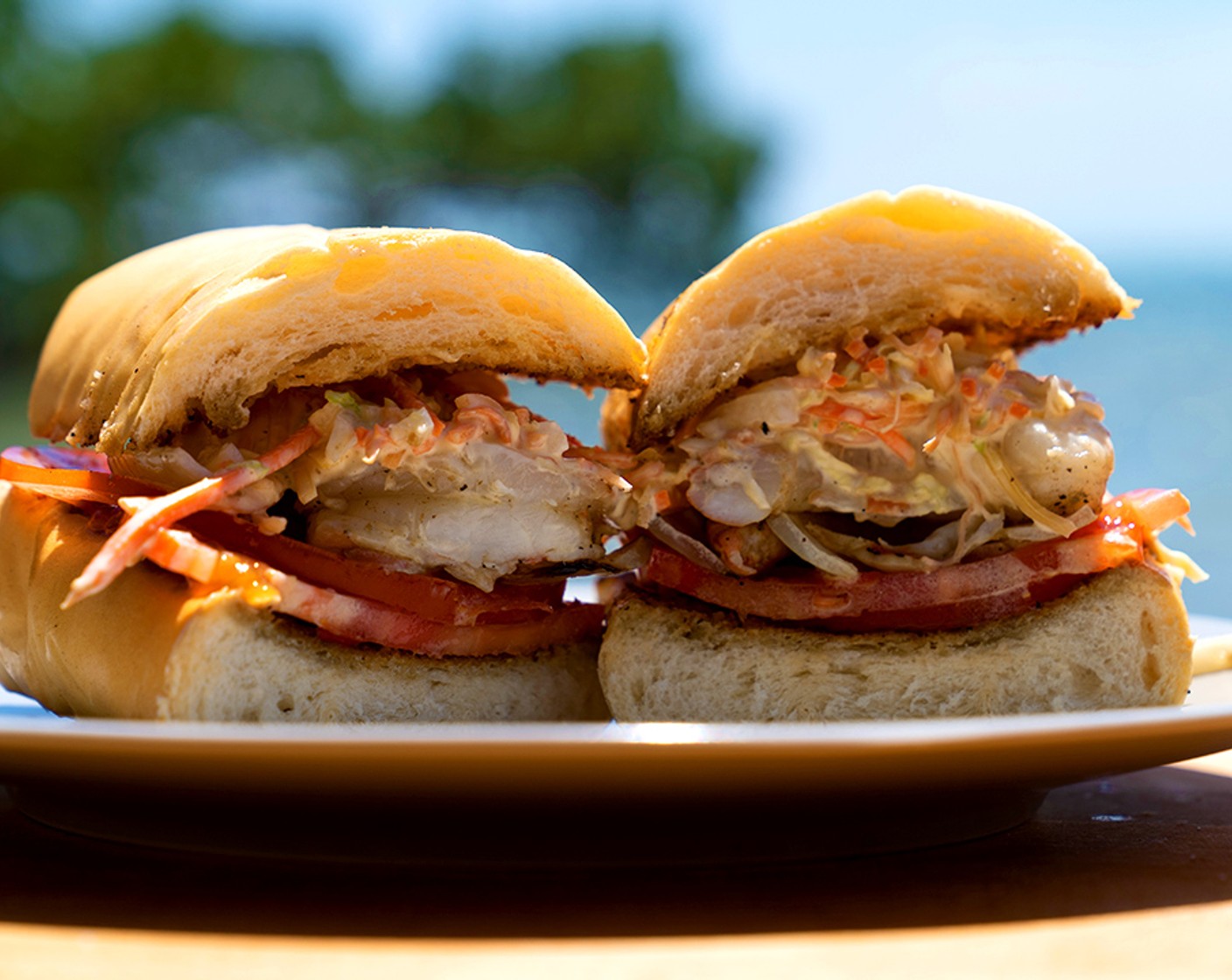 step 7 Assembly: Placed Tomato (1) on the bottom of the po boy bread roll.
Next grilled onion then layer the shrimp on top of the onions.
Finished with slaw, Dijon Mustard (1 tsp) and the top piece of po boy bread.