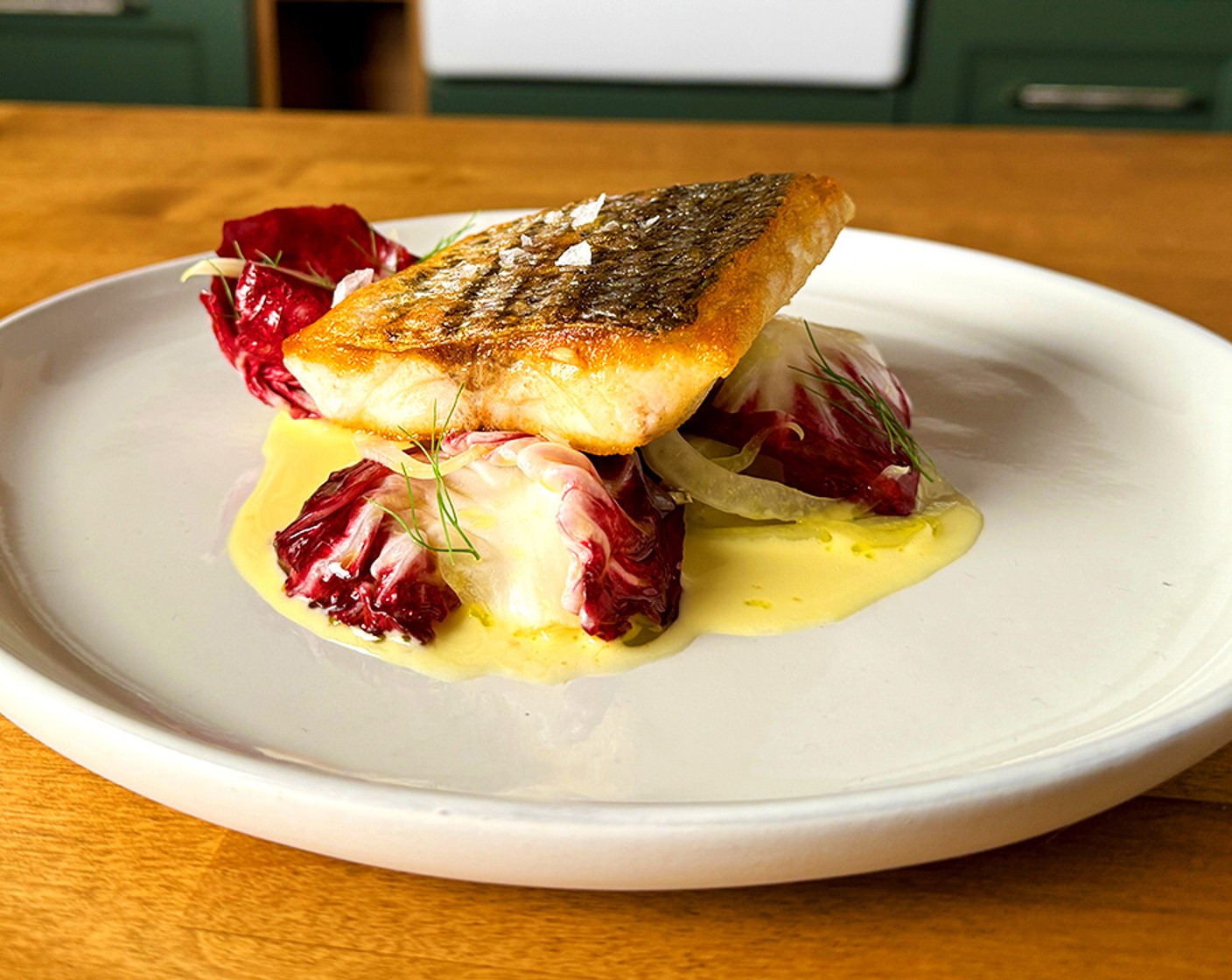 step 6 To serve: Spoon the poached kohlrabi on to the plate and top with the fish. Drizzle the beurre blanc around the fish and finish with the radicchio salad.