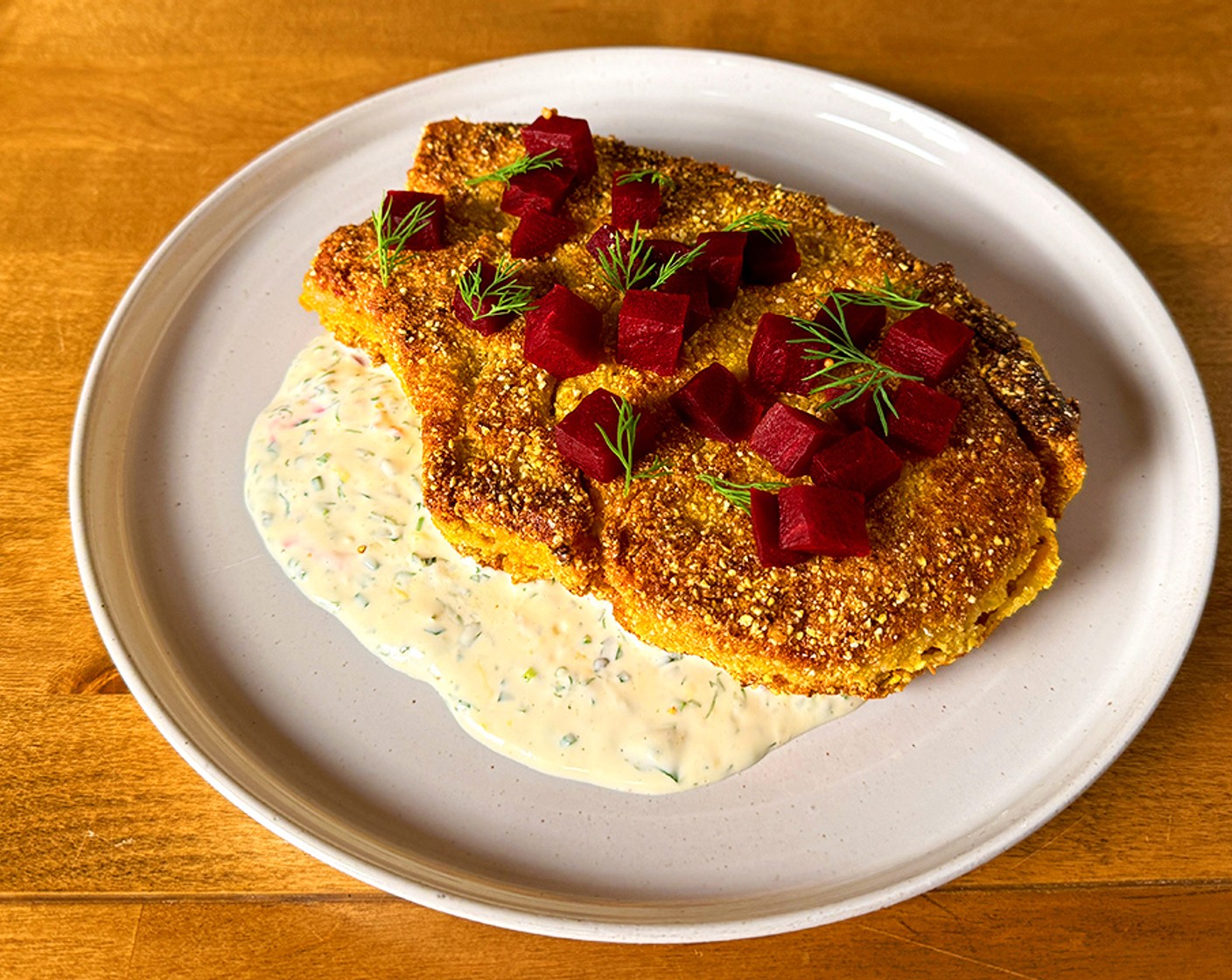 step 6 To serve: Place the buttermilk sauce on a plate with the pork chop on top. Scatter pickled beets along the pork chop and finish with dill springs.